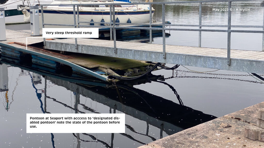 Shows wood surfaced linking gangway connecting to a boat mooring pontoon which is falling apart at the inward end