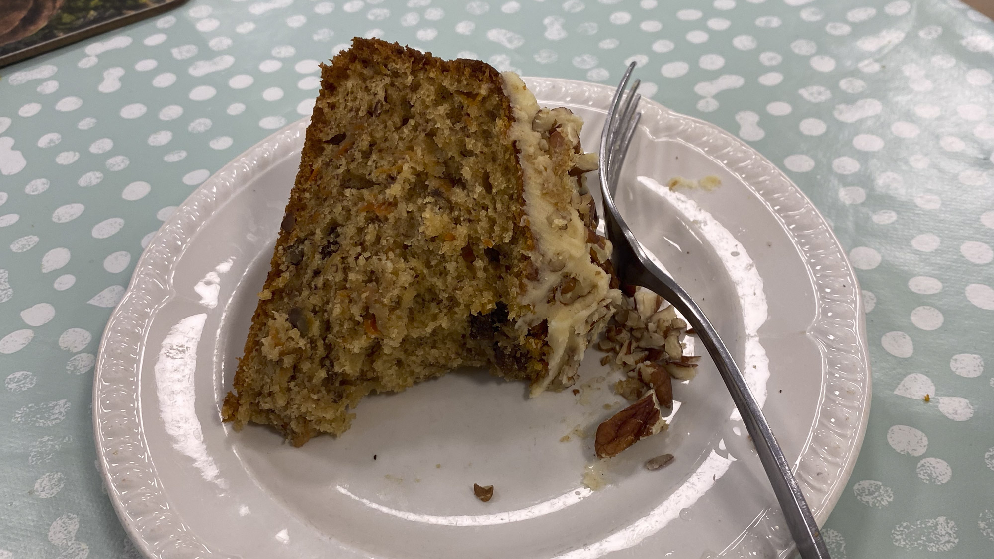 A piece of carrot cake on a white plate.