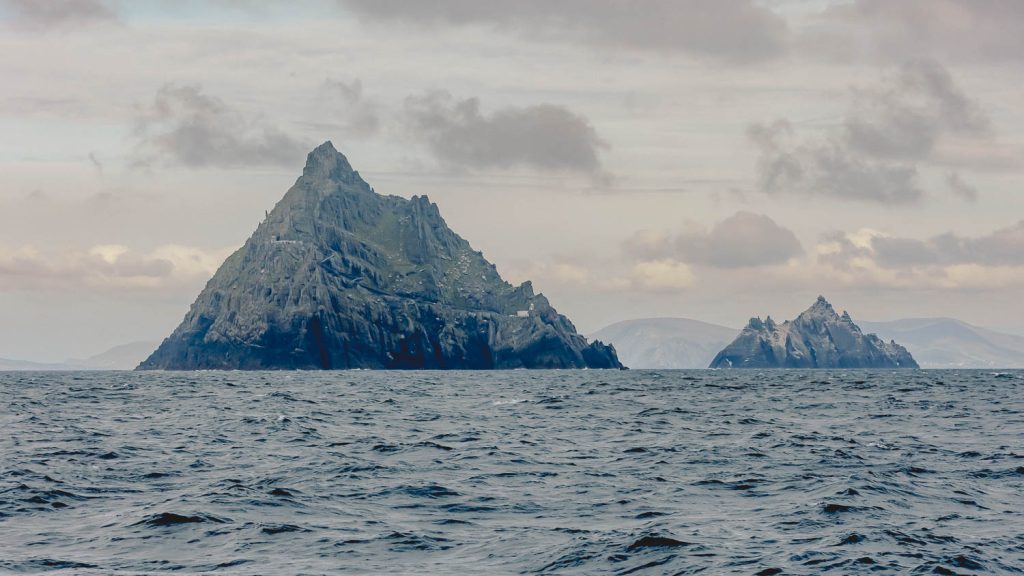 craggy triangular mountains rise out of the sea
