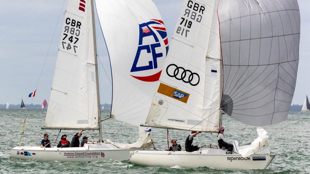 Two sonar's racing on flat water under spinnaker